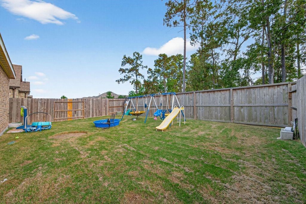 12154 Texas Trumpet Trail Humble, TX 77346 - Photo 21 of 21 a view of a garden with a slide