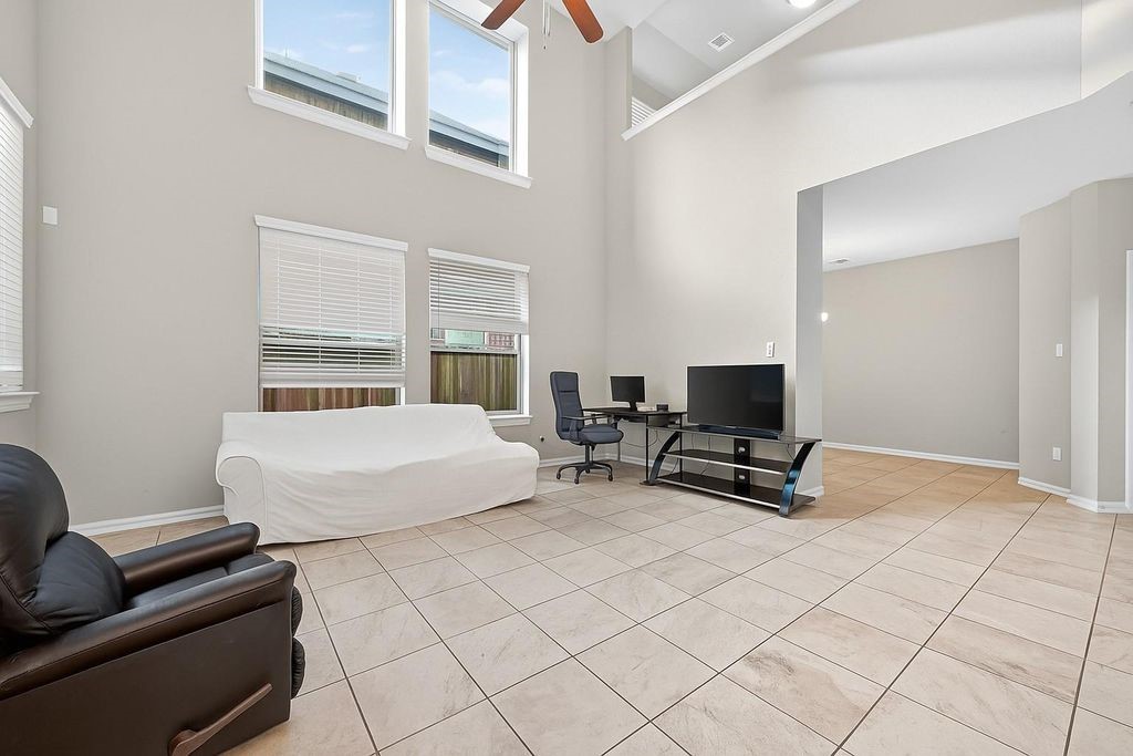 12154 Texas Trumpet Trail Humble, TX 77346 - Photo 5 of 21 a bedroom with furniture and a couch