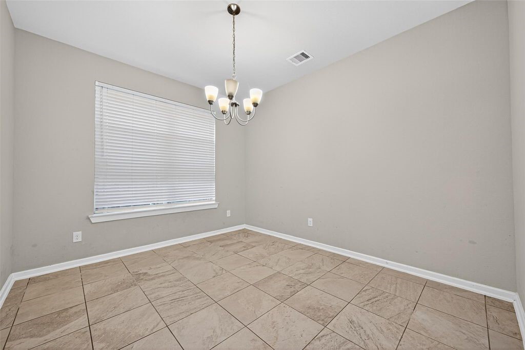 12154 Texas Trumpet Trail Humble, TX 77346 - Photo 8 of 21 a view of an empty room with a window