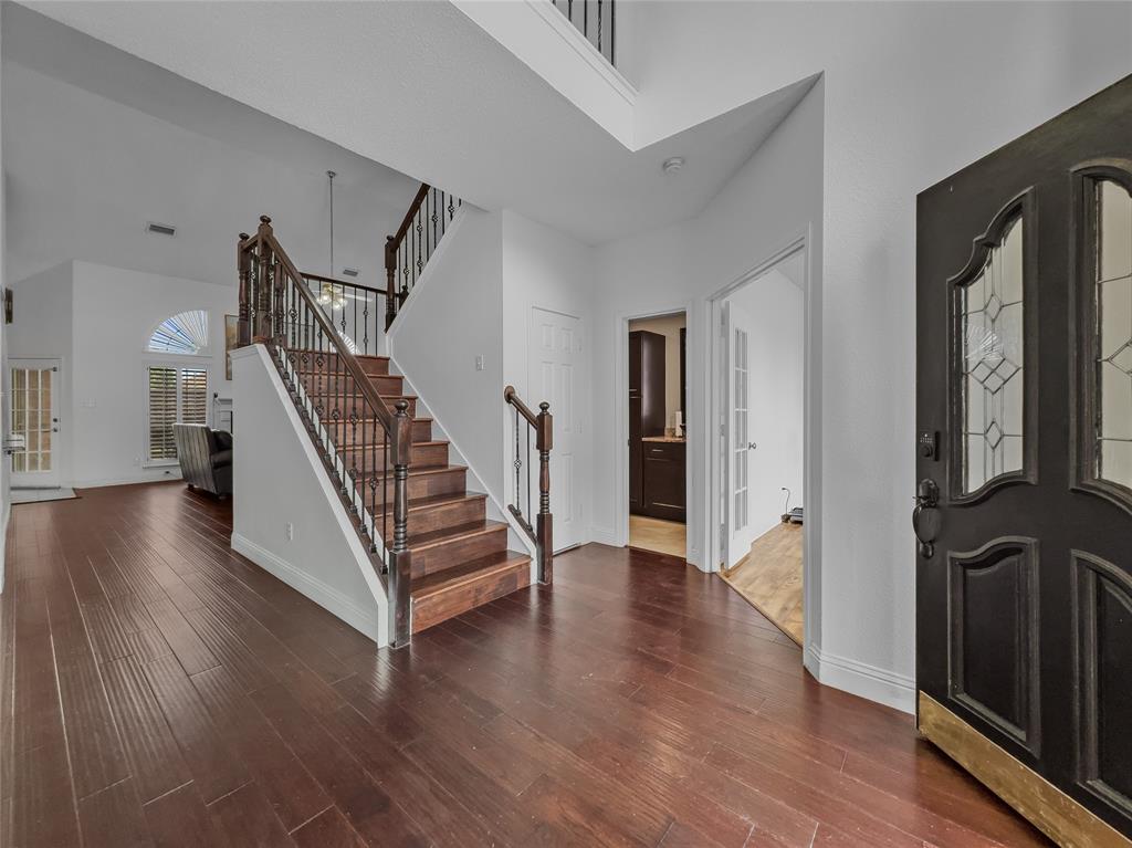 2317 Wellesly Road Rowlett, TX 75089 - Photo 7 of 39 a view of a hallway with wooden floor and stairs