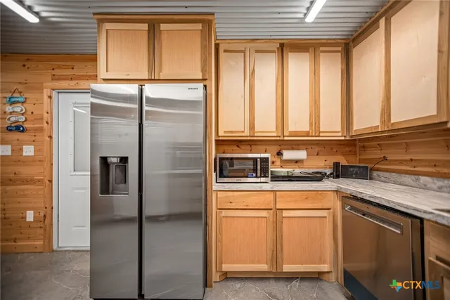 a kitchen with granite countertop a sink and a window