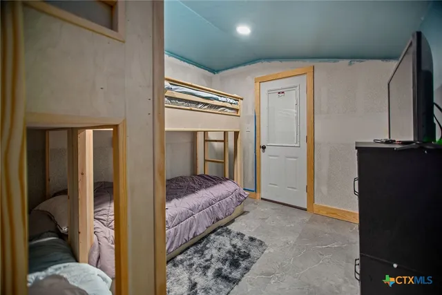 a bed room with a bed and a window