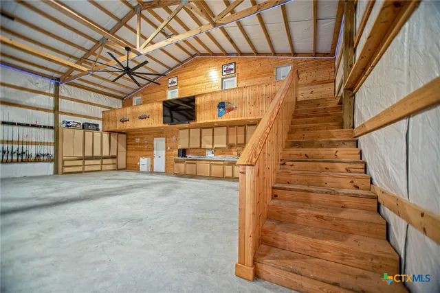 a view of an empty room with a staircase
