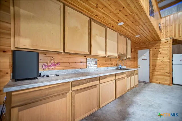 a kitchen with stainless steel appliances granite countertop a refrigerator and a stove
