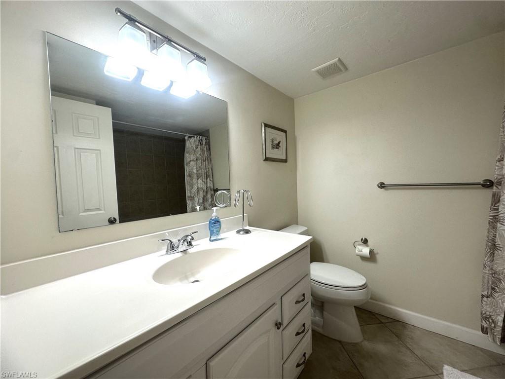2375 Naples Trace Circle, Unit 7 Naples, FL 34109 - Photo 22 of 28 a bathroom with a sink toilet and a mirror