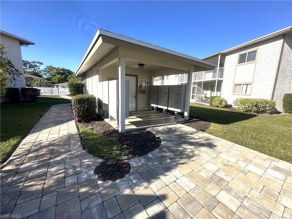 2375 Naples Trace Circle, Unit 7 Naples, FL 34109 - Photo 25 of 28 a view of a house with backyard and garden