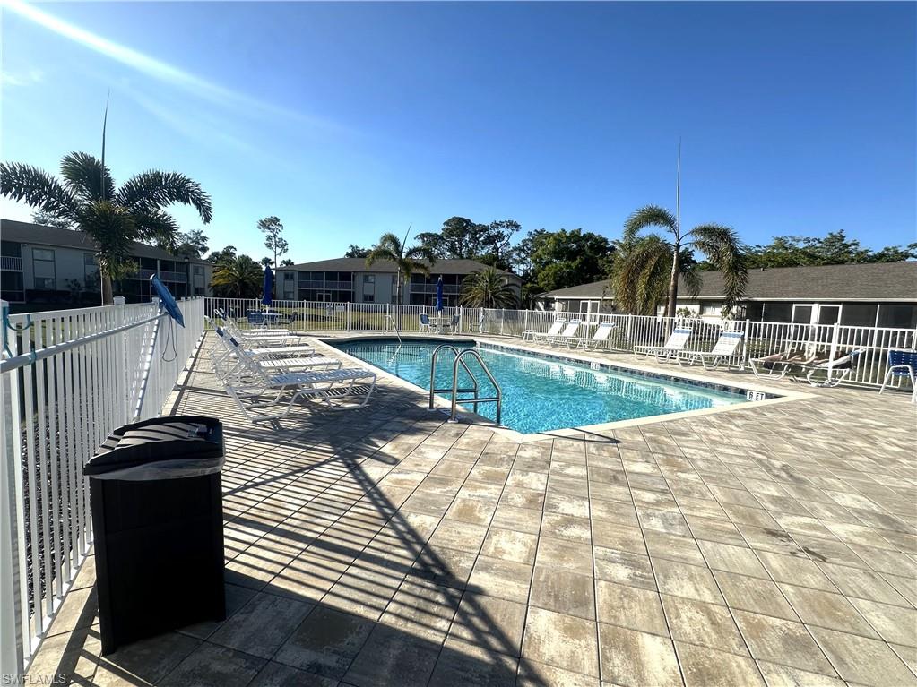 2375 Naples Trace Circle, Unit 7 Naples, FL 34109 - Photo 27 of 28 a view of a swimming pool with a patio