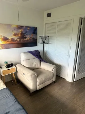 a white toilet sitting next to a shower