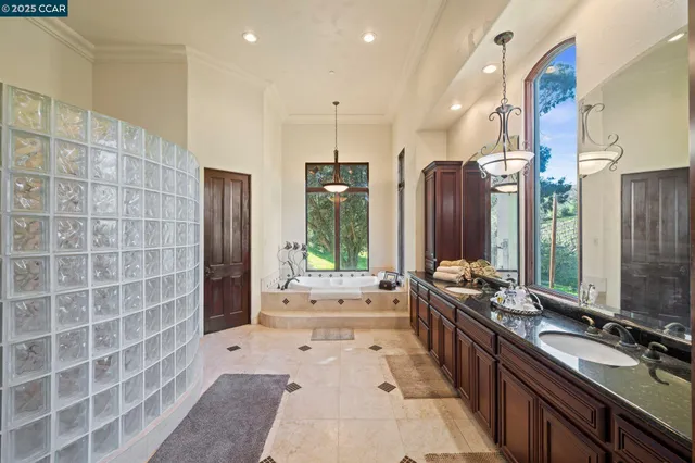a large bathroom with a large tub and sink