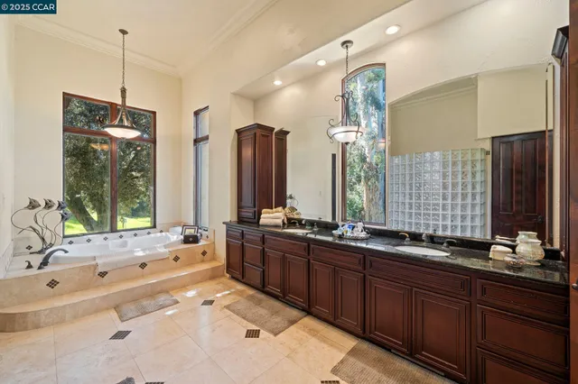 a bedroom with a bed mirror and window