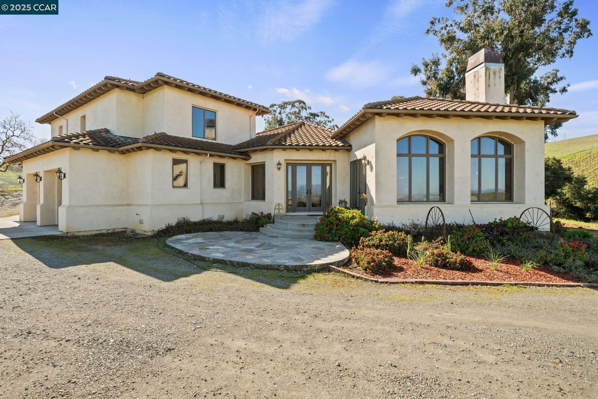 633 Kalthoff Common Livermore, CA 94550 - Photo 2 of 60 a view of a white house with large windows and a yard