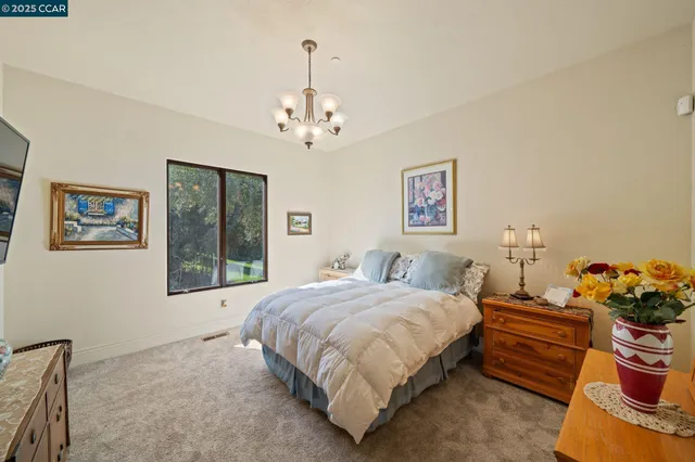 a bathroom with a granite countertop toilet a sink and a mirror