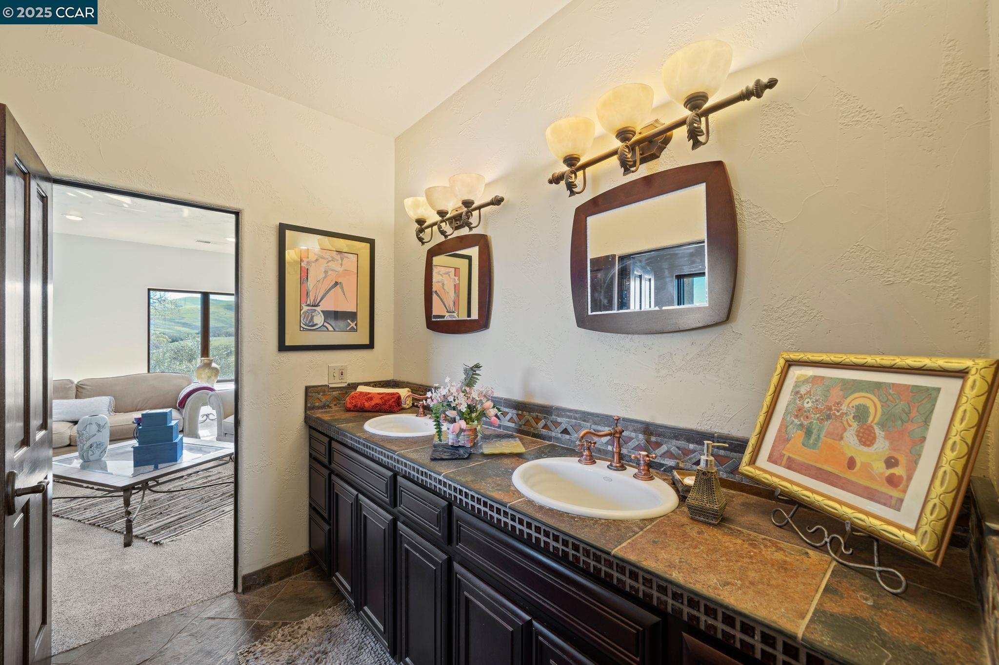 633 Kalthoff Common Livermore, CA 94550 - Photo 24 of 60 a bathroom with a granite countertop sink a mirror and a toilet