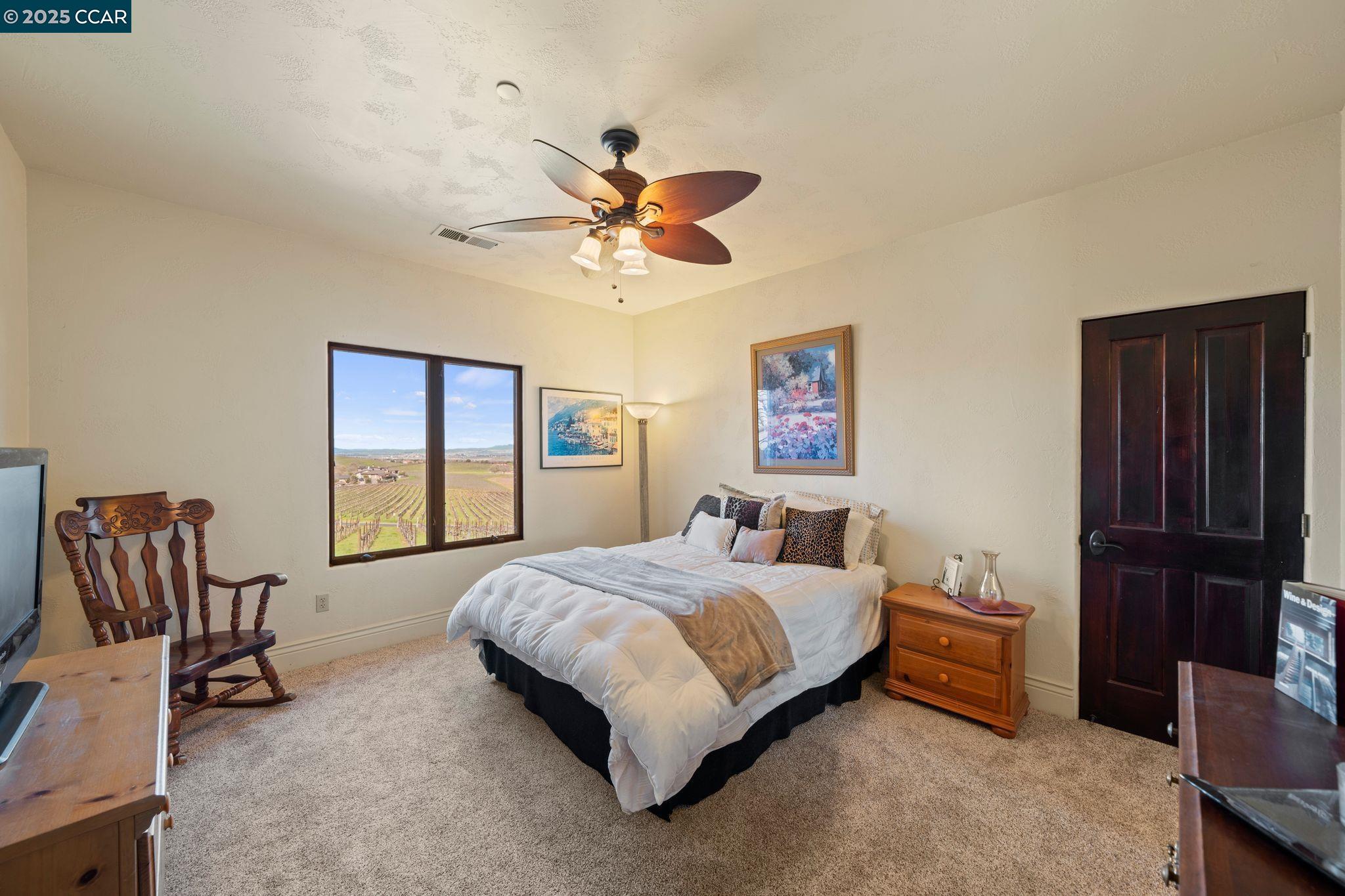 633 Kalthoff Common Livermore, CA 94550 - Photo 25 of 60 a bedroom with a bed and a chandelier