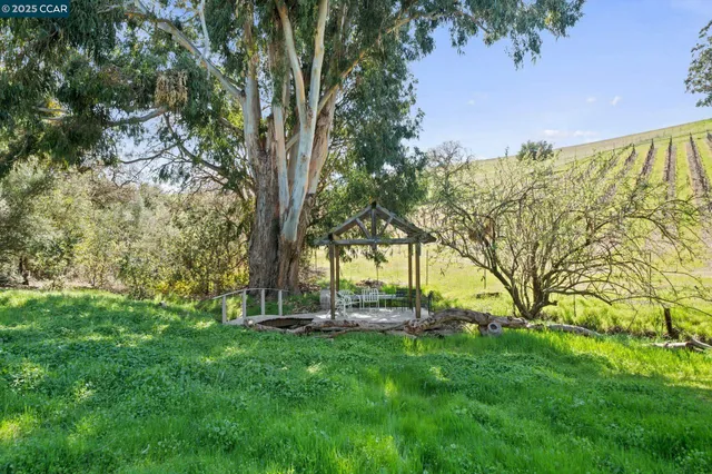 a view of a house with swimming pool and sitting area