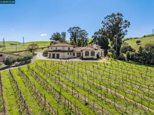 a patio with a table and chairs under an umbrella