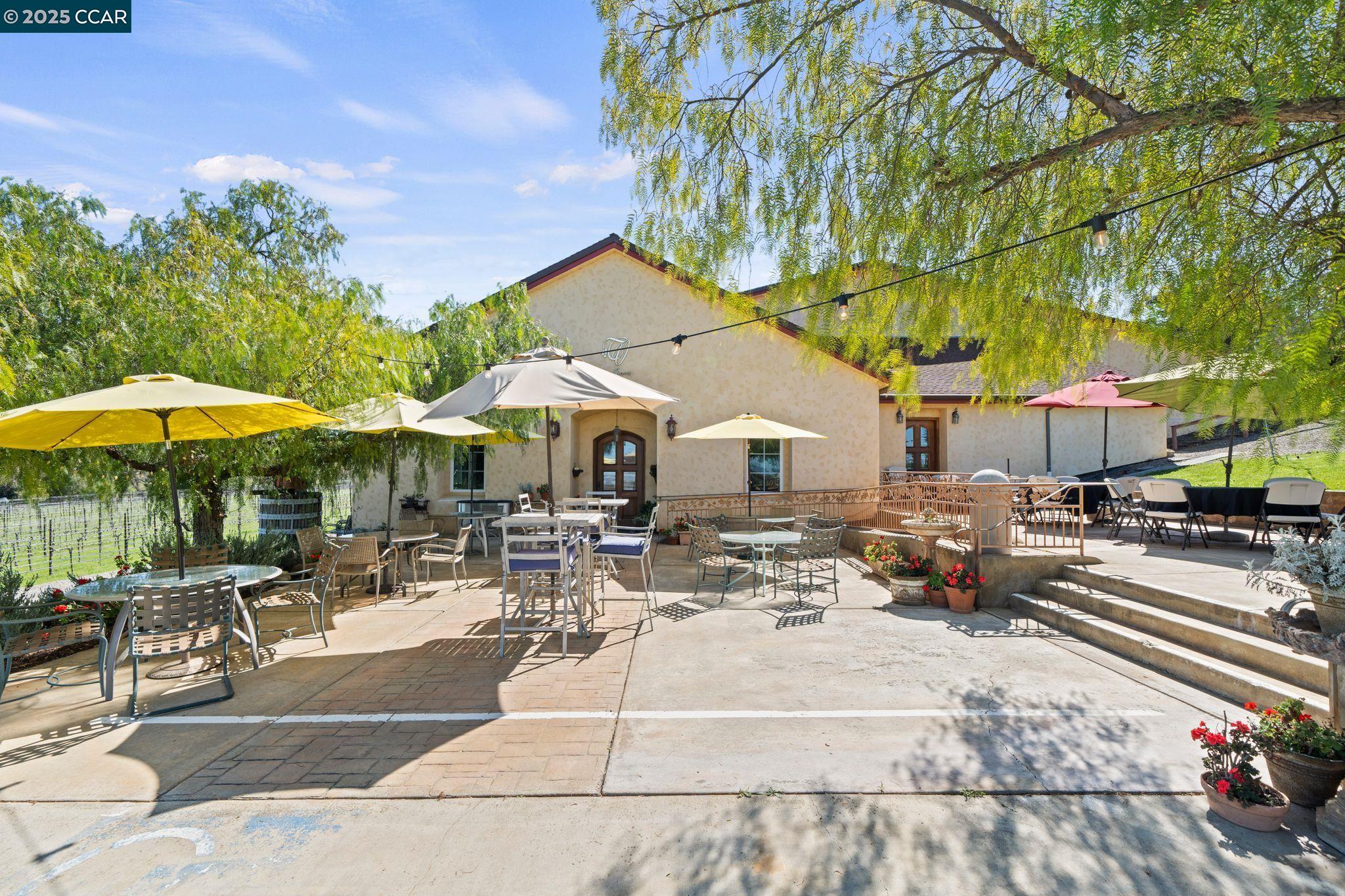 633 Kalthoff Common Livermore, CA 94550 - Photo 39 of 60 a patio with a table and chairs under an umbrella