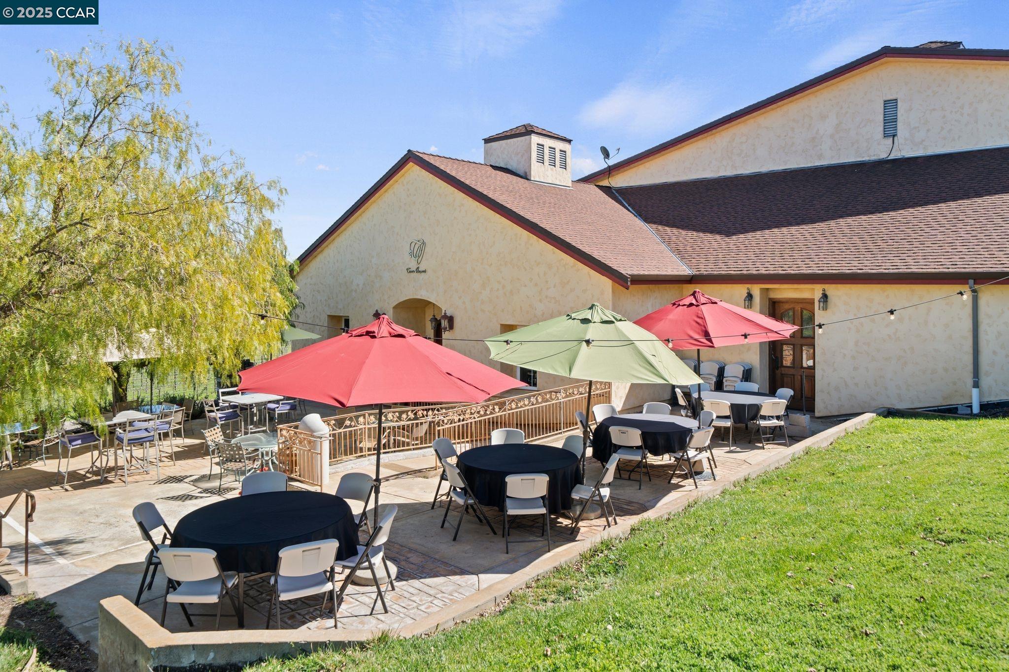633 Kalthoff Common Livermore, CA 94550 - Photo 40 of 60 a patio with a table and chairs under an umbrella