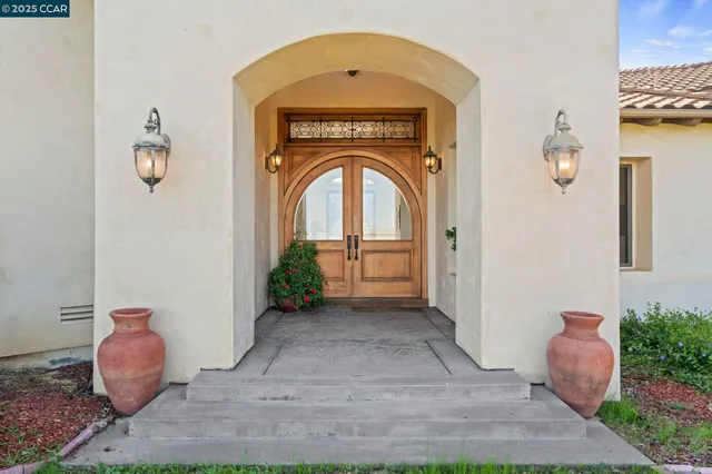 a view of a hallway with entryway wooden floor and a chandelier