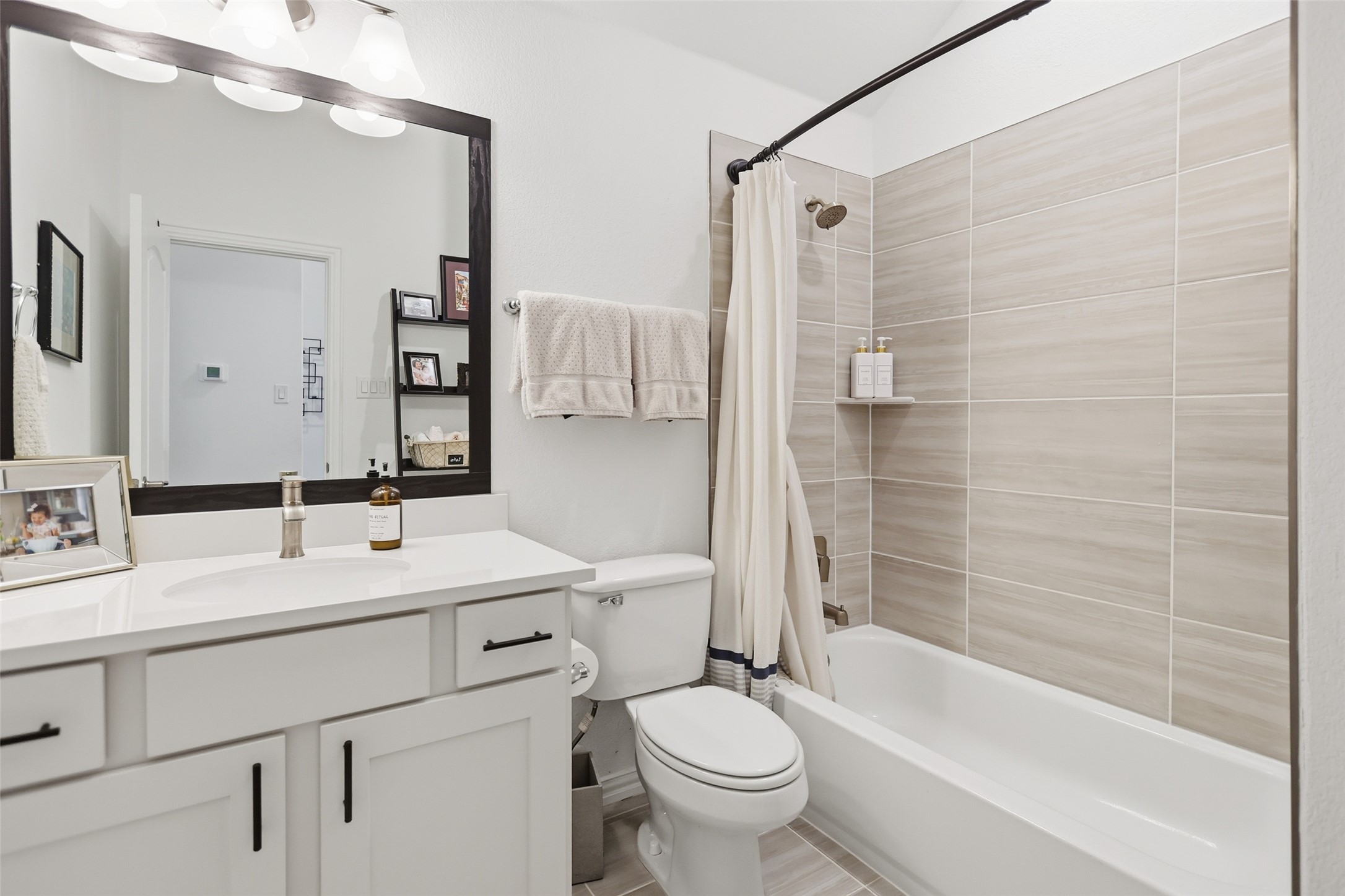 544 Cherrystone Loop Buda, TX 78610 - Photo 26 of 40 a bathroom with a double vanity sink toilet mirror and shower