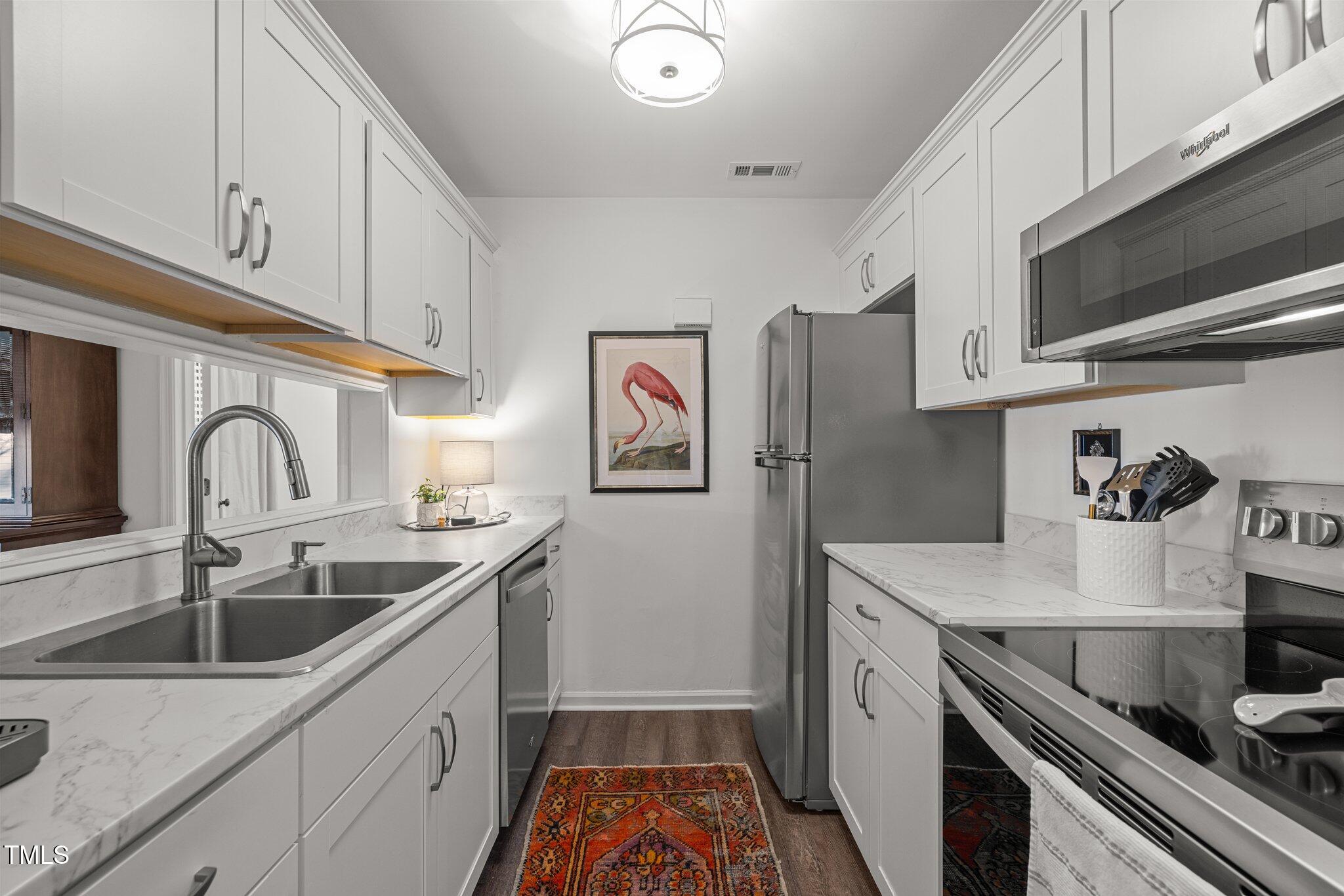 3643 Mill Run Raleigh, NC 27612 - Photo 6 of 26 Great kitchen storage with a convenient pass-through to dining room.