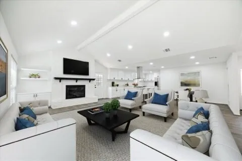 a living room with fireplace furniture and a flat screen tv