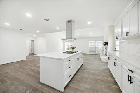 a kitchen with a sink cabinets and wooden floor