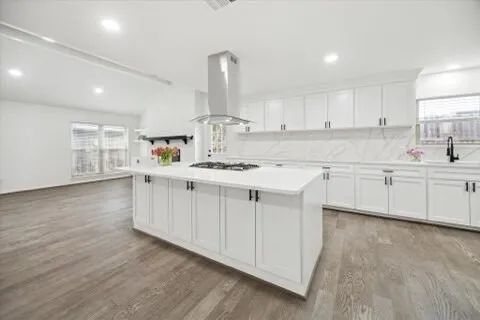 a kitchen with a stove a sink and a microwave