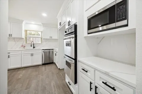 a view of a room with wooden floor