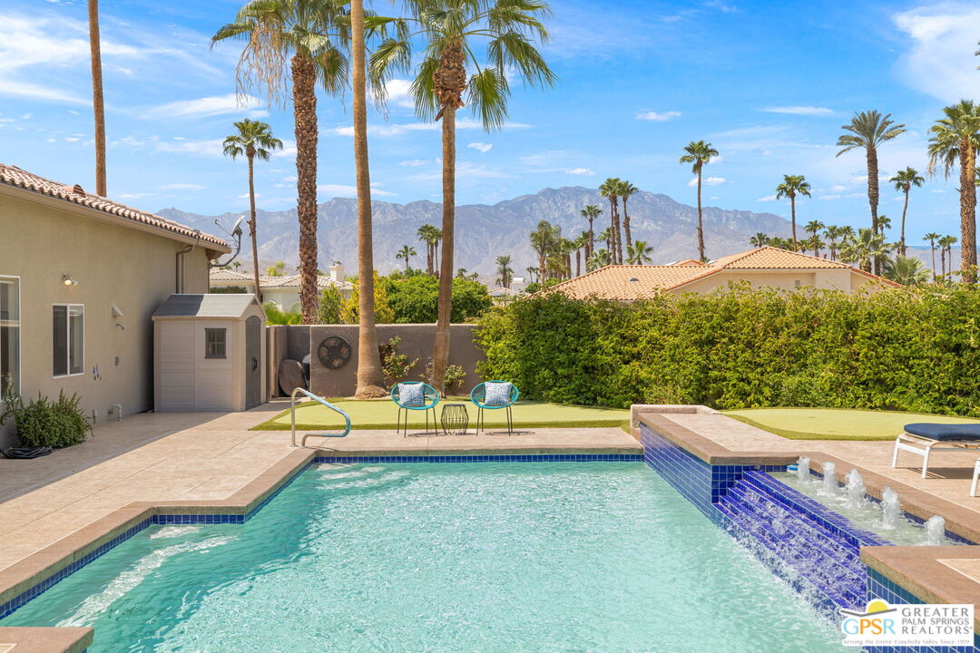 36630 Palm Court Rancho Mirage, CA 92270 - Photo 2 of 46 a view of a swimming pool with a lounge chairs