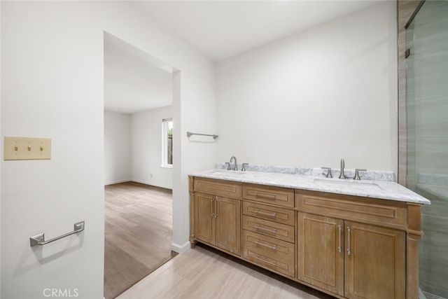 a bathroom with a double vanity sink and mirror