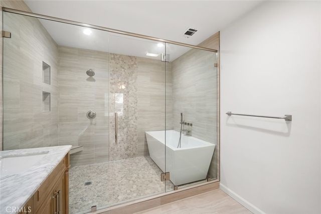 a bathroom with a bathtub and shower