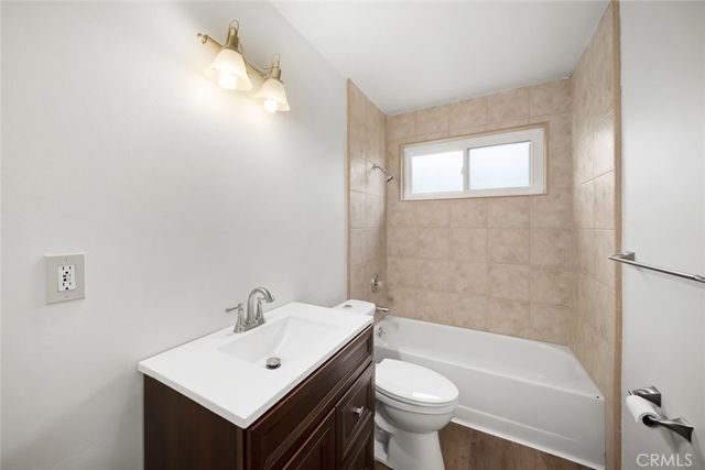 a bathroom with a sink a toilet and bathtub