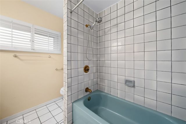 a bathroom with a bathtub and next to a window