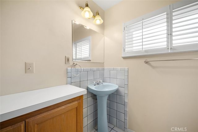 a bathroom with a sink a vanity and a mirror