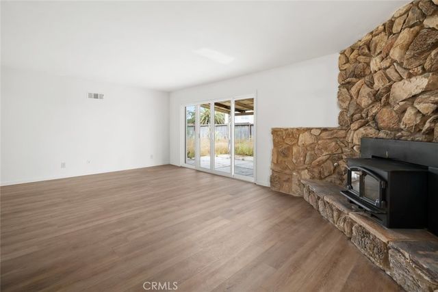 a view of empty room with window and fireplace