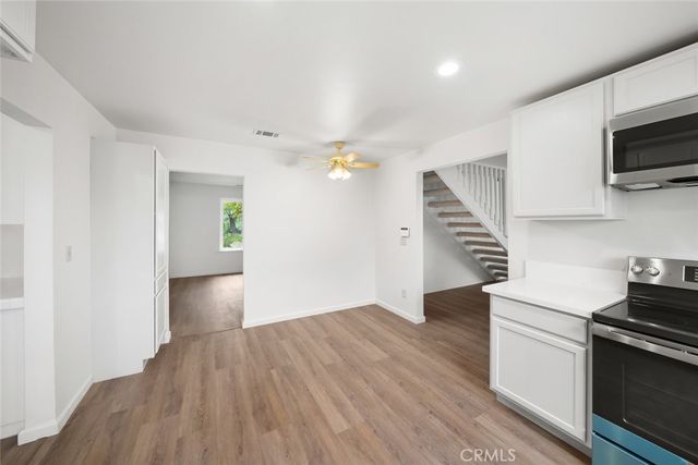 a view of kitchen with sink and stainless steel appliances