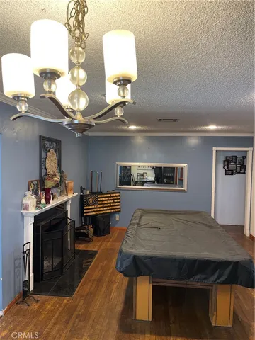 a view of a hallway with entryway wooden floor and livingroom