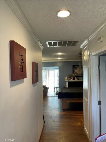 a view of a hallway with wooden floor windows