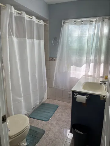 a view of a room with wooden floor and fan
