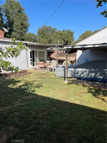 a living room with furniture and a glass door