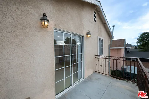 a view of a house with wooden fence