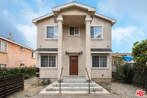 a white toilet sitting next to a bath tub