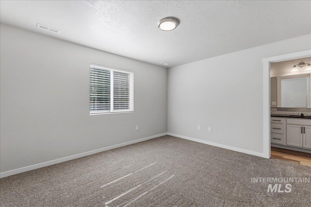 3091 S Green Boise, ID 83709 - Photo 13 of 27 Carpeted room with light grey walls and a single window with blinds