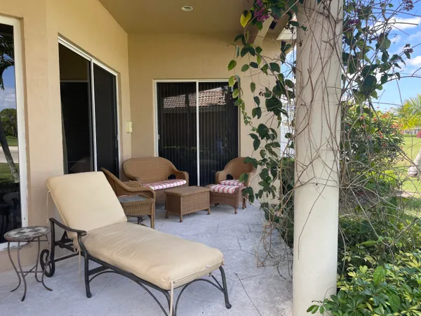 a outdoor space with patio couch and a potted plant