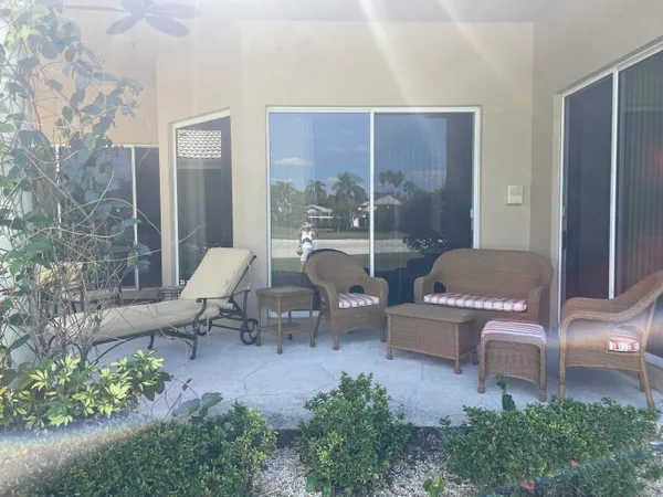 a living room with furniture and a floor to ceiling window