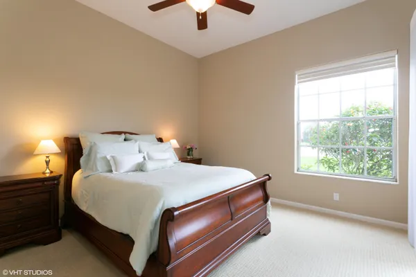 a bed sitting in a bedroom next to a window