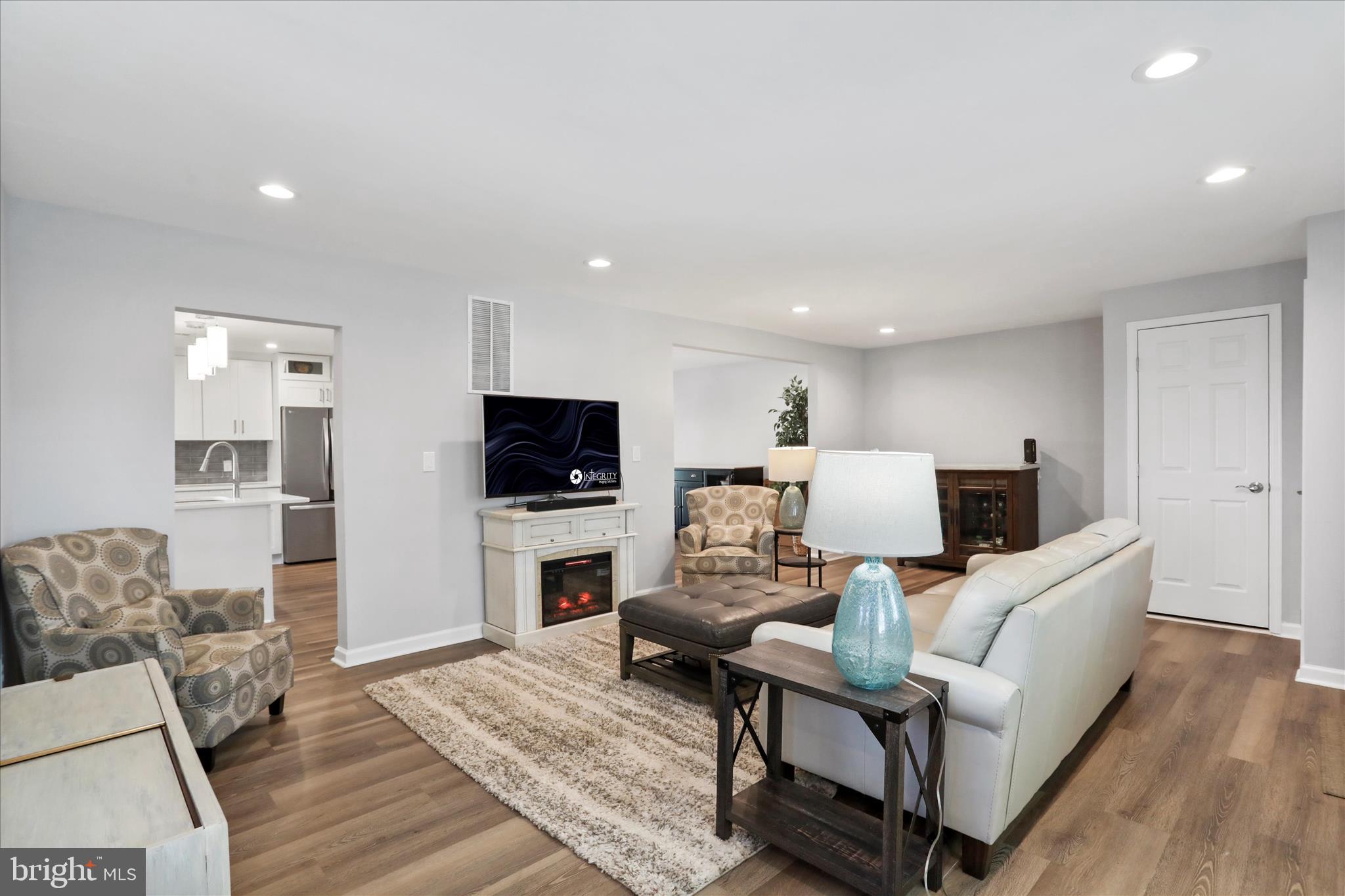 408 Blue Ridge Avenue Northeast Leesburg, VA 20176 - Photo 12 of 36 a living room with furniture and a flat screen tv