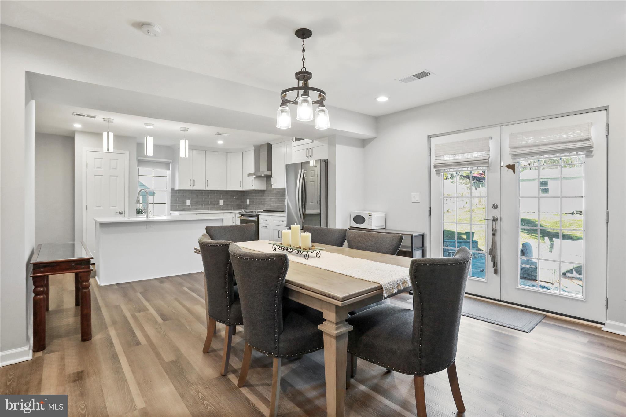408 Blue Ridge Avenue Northeast Leesburg, VA 20176 - Photo 17 of 36 a view of a dining room with furniture window and wooden floor