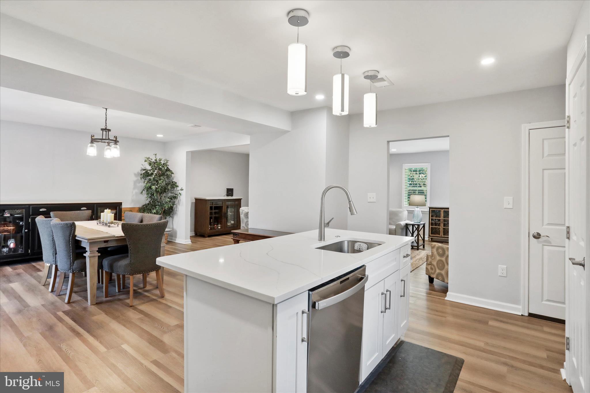 408 Blue Ridge Avenue Northeast Leesburg, VA 20176 - Photo 21 of 36 a living room with furniture a dining table and chairs with wooden floor